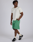 Angled view of Longline Work Shorts in Seafoam Green and Burly Tee in Vintage Tee White