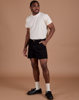 Angled front view of Classic Work Shorts in Basic Black and Organic Vintage Tee in Vintage Off White on Isaac