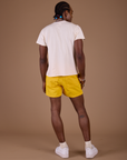 Back view of Classic Work Shorts in Sunshine Yellow and Organic Vintage tee in Vintage Off White on Jerrod