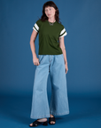 Alex is wearing Painted Vintage Tee in Evergreen and light wash Indigo Wide Leg Trousers