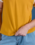 Painted Burly Tee in Mustard Yellow close up on Alex