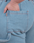 Close up of Ashley's hand in the back pocket of Carpenter Jeans in Light Wash