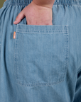 Close up of Juliet's hand in the back pocket of Denim Drop Pocket Pants in Light Wash