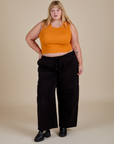 Juliet is wearing Muscle Tee in Creamsicle Orange and black Drop Pocket Cargo Pants