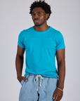 Isaac is wearing Jr. Varsity Tee in Hawaiian Blue