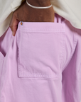 Close up of Isaac's hand in the back pocket of Longline Work Shorts in Lilac Purple