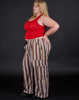 Side view of Striped Drop Pocket Pants in Retro Rainbow and mustang red Tank Top