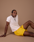 Jerrod is wearing Classic Work Shorts in Sunshine Yellow and Organic Vintage Tee in Vintage Off White