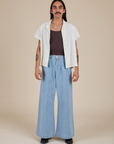 Anthony is wearing Pantry Button-Up in Vintage Tee White and light wash Indigo Wide Leg Trousers
