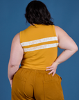 Painted Muscle Tee in Mustard Yellow back view on Ashley