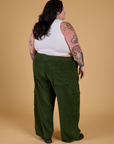 Angled back view of Corduroy Drop Pocket Cargo Pants in Evergreen and Cropped Tank in Vintage Tee White on Sam
