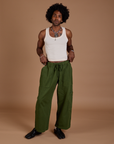 Jerrod is wearing Drop Pocket Cargo Pants in Evergreen and Tank Top in vintage tee white