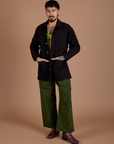 Jesse is wearing Ripstop Field Coat in Basic Black and evergreen Drop Pocket Cargo Pants