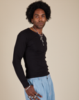 Long Sleeve Baby Tee in Basic Black side view on Jerrod