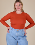 Lish is 5’8” and wearing XS Long Sleeve Baby Tee in Chili Red