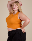 Angled front view of Muscle Tee in Creamsicle Orange on Juliet