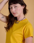 Angled front view close up of Organic Vintage Tee in Sunshine Yellow on Alex