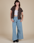 Alex is wearing Pantry Button-Up in Espresso Brown and light wash Indigo Wide Leg Trousers