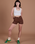 Alex is wearing Classic Work Shorts in Fudgesicle Brown and a Cropped Tank in Vintage Tee White
