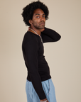 Side view of Long Sleeve Baby Tee in Basic Black on Jerrod