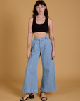 Alex is wearing Mini Tank in Basic Black and light wash Indigo Wide Leg Trousers