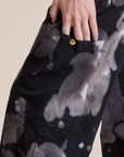 Close up of Alex's hand tucked into the side pant leg pocket of Magic Waters Drop Pocket Pants in Ink Blot