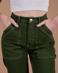 Front close up of Carpenter Jeans in Evergreen on Alex