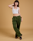 Alex is wearing Baggy Mid-Rise Trousers in Evergreen and a vintage tee white Cropped Tank