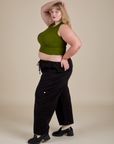 Side view of Muscle Tee in Summer Olive on black Drop Pocket Cargo Pants on Juliet