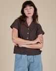Alex is wearing a buttoned up Pantry Button-Up in Espresso Brown
