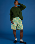 Jerrod is wearing Longline Work Shorts in Spring Quilt Print and Long Sleeve Burly Tee in Evergreen