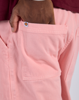 Close up of Isaac's hand in the back pocket of Work Pants in Baby Pink