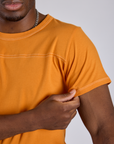 Close up of Jr. Varsity Tee in Creamsicle Orange on Isaac