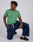 Jr. Varsity Tee in Seafoam Green and dark wash Denim Drop Pocket Pants on Isaac