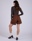 Pleated Trouser Shorts in Fudgesicle Brown back view on Alex
