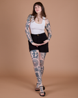 Sydney is 5’9” and wearing M Classic Work Shorts in Basic Black paired with a Cropped Tank in Vintage Tee White