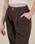 Close up of Alex's hand in the front pocket of Heavyweight Trousers in Espresso Brown