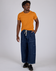 Jr. Varsity Tee in Creamsicle Orange and dark wash Denim Drop Pocket Pants on Isaac