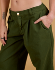 Close up of Alex's hand in the front pocket of Baggy Mid-Rise Trousers in Evergreen