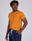 Angled Jr. Varsity Tee in Creamsicle Orange angled front view on Isaac