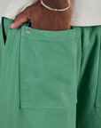 Close up of Isaac's hand in the back pocket of Drop Pocket Cargo Pants in Seafoam Green