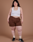 Ashley is 5’7” and wearing 1XL Classic Work Shorts in Fudgesicle Brown paired with a Cropped Tank in Vintage Tee White