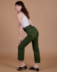 Carpenter Jeans in Evergreen side view on Alex