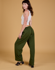 Angled back view of Baggy Mid-Rise Trousers in Evergreen on Alex