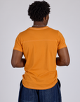 Jr. Varsity Tee in Creamsicle Orange back view on Isaac