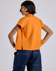 Pantry Button-Up in Creamsicle Orange back view on Kira
