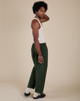 Side view of Heavyweight Trousers in Swamp Green and Tank Top in Vintage Tee Off-White on Jerrod