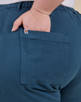 Close up of Ashley's hand in the back pocket of Work Pants in Lagoon