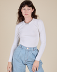 Alex is 5’8” and wearing P Long Sleeve Baby Tee in Vintage Tee Off-White
