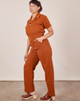 Side view of Short Sleeve Jumpsuit in Burnt Terracotta worn by Tiara